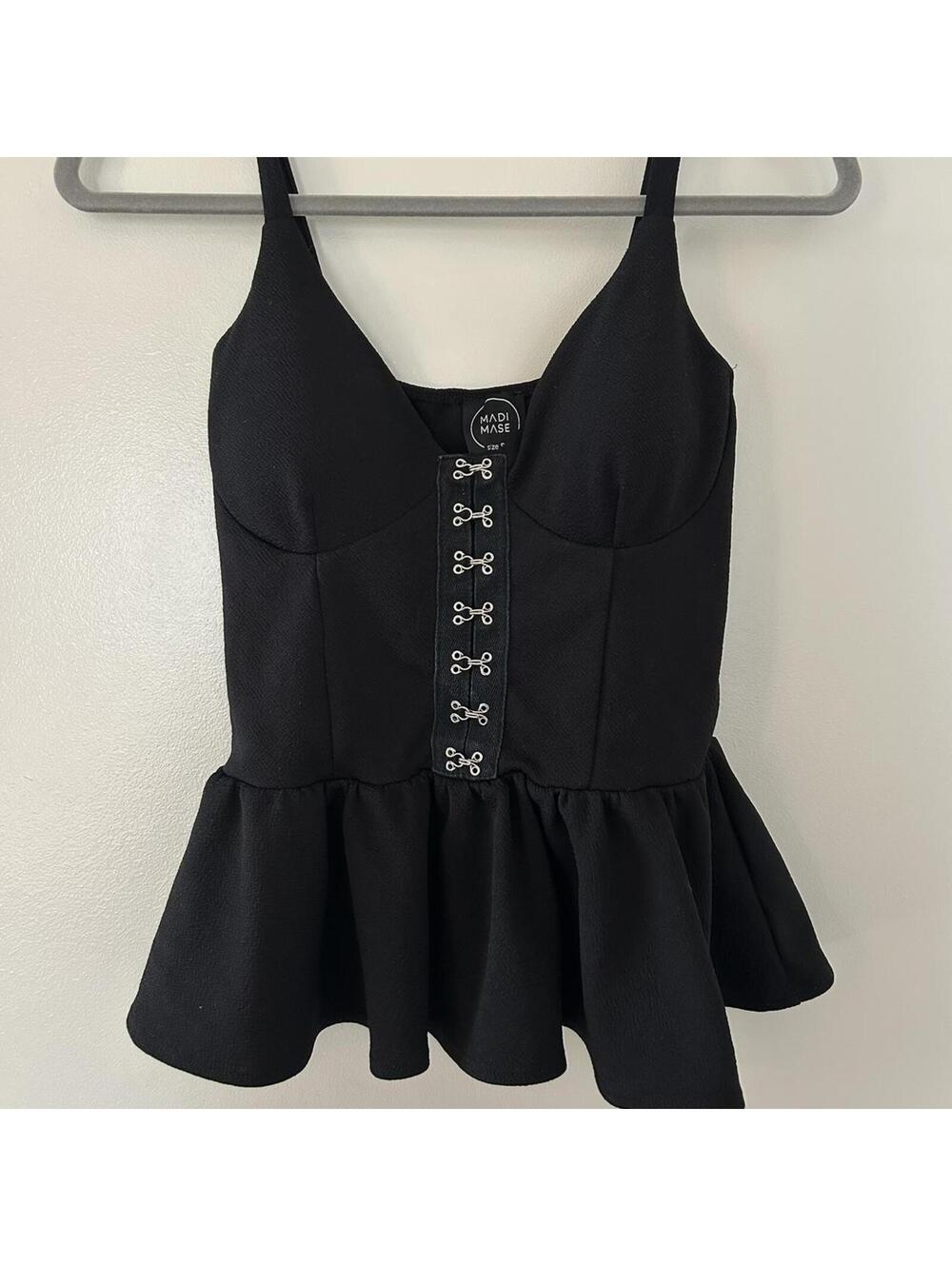 Black corset top with lace up front and peplum hem